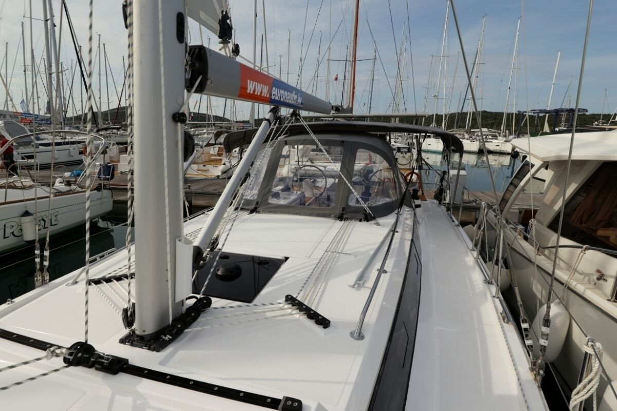 A marina with multiple sailboats docked.