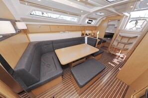 A compact galley with a bench seating area, a small table, and a galley counter. - Sun-Kissed Sailing Adventure in Zadar, Croatia (Biograd na moru)