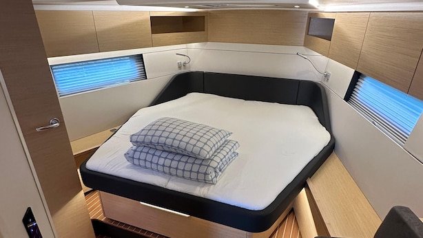 A compact, modern cabin with a bed, built-in storage, and skylights. - Sun-Kissed Sailing Adventure in Northern Croatia (Punat)