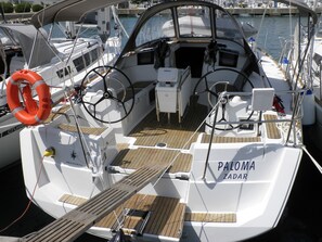 A boat deck with a steering wheel, life preserver, and name 'PALOMA ZADOR' visible. - Sun-Kissed Sailing Adventure in Zadar, Croatia (Bibinje)