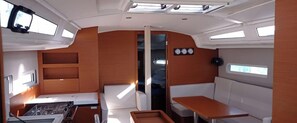 A compact galley with a stove, a sink, and a small table. - Sun-Kissed Sailing Adventure in Tenerife, Islas Canarias (Las Galletas)