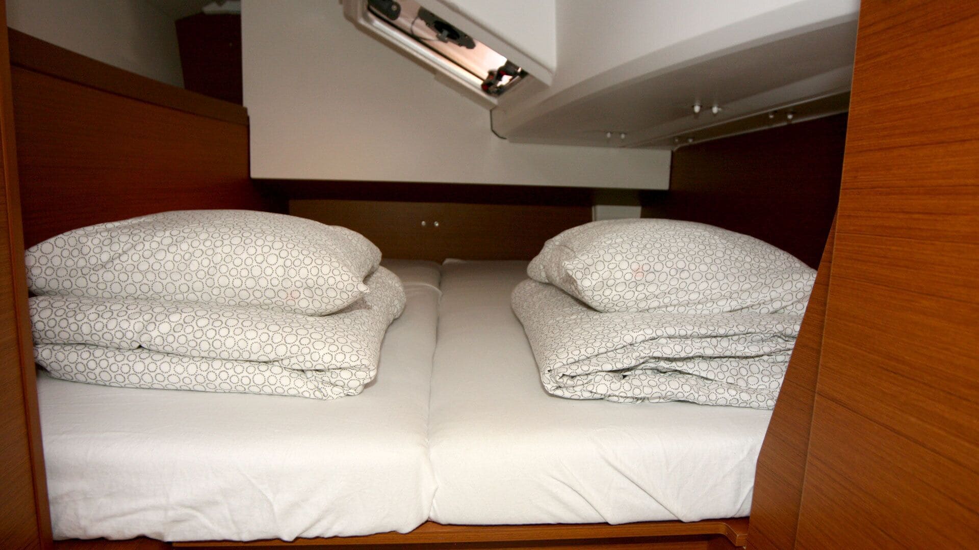 A bunk bed with two pillows and a white mattress.