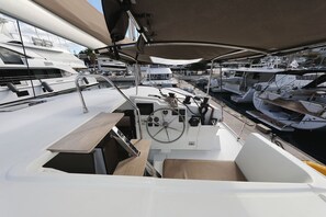 A marina with multiple yachts docked, a steering wheel, and a control panel. - Sun-kissed Sailing Adventure in Split-Dalmatia, Croatia (Trogir)