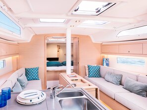 A compact RV interior with a kitchenette, a dining area, a sleeping berth, and a bathroom. - Sun-Kissed Sailing Adventure in the Ionian Islands, Lefkada (Lefkada)