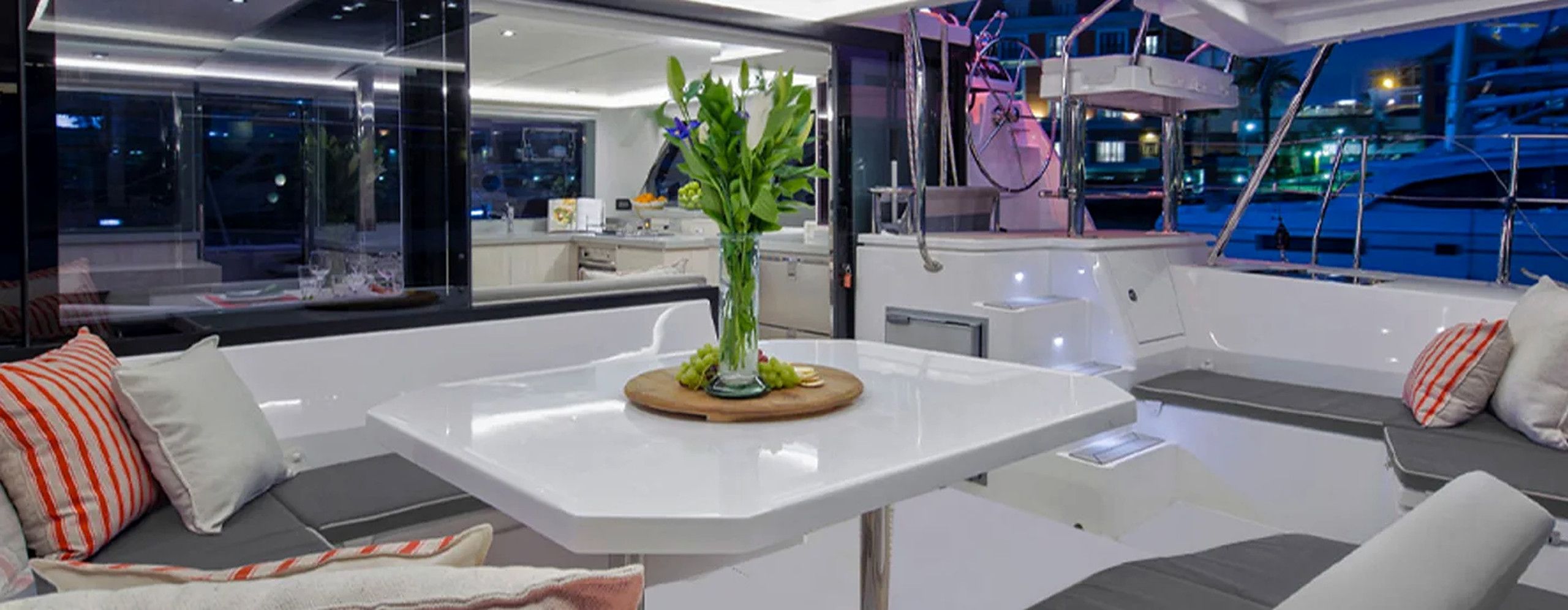 A modern interior with a white table, seating area, and a view of the outside.