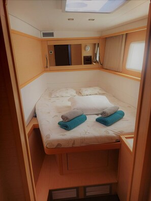 A compact, well-lit cabin with a bed, storage cabinets, and a small window. - Sun-Kissed Sailing Adventure in Split, Croatia (Split)