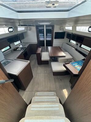 A compact interior with a kitchenette, seating area, and a small table with a board game.