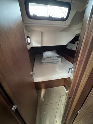 A compact, well-lit interior with a bunk bed, a small window, and a door. - Sun-Kissed Sailing Adventure in Zadar, Croatia (Biograd na moru)