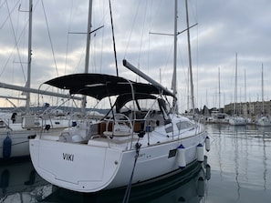 A marina with multiple sailboats docked, featuring a white boat with 'VIKI' on the bow. - Sun-Kissed Sailing Adventure in Istria, Croatia (Pula)