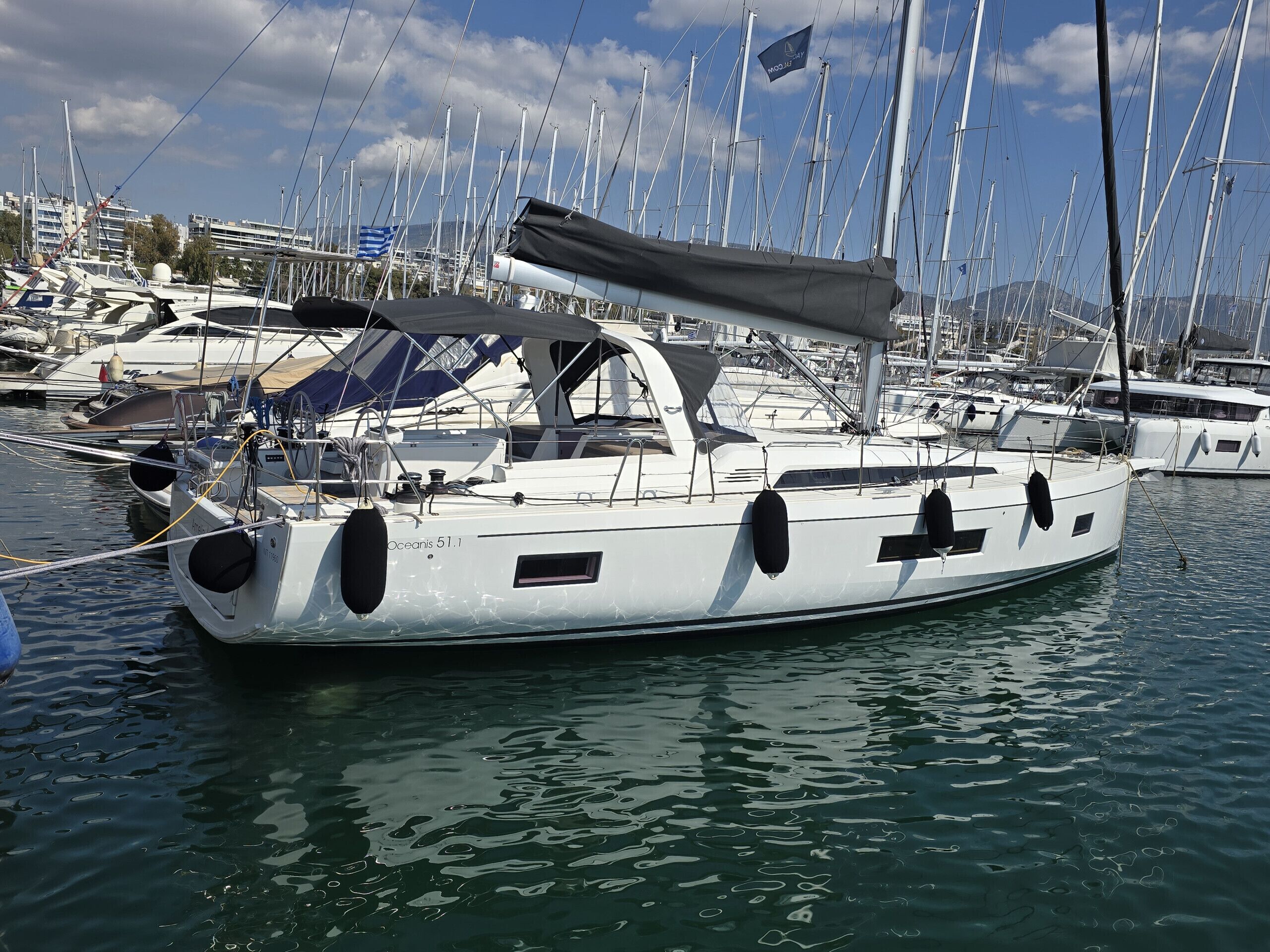 A marina with multiple sailboats docked.