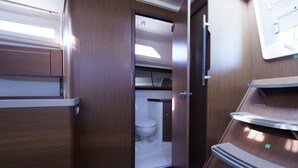 A compact, modern bathroom with a toilet, a sink, and a shower area. - Sun-Kissed Sailing Adventure in the Ionian Islands, Lefkada (Lefkada)
