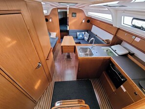A compact galley with a sink, stove, and storage cabinets. - Sun-Kissed Sailing Adventure in Zadar, Croatia (Bibinje)