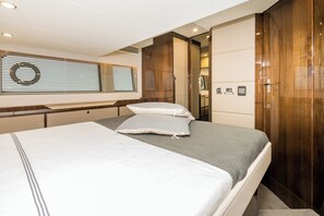 A modern hotel room with a large bed, a wooden wardrobe, and a window with blinds. - Sun-Kissed Sailing Adventure in Zadar, Croatia (Drage)