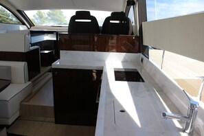 A boat interior with seating, a sink, and a window. - Sun-Kissed Sailing Adventure in Zadar, Croatia (Drage)
