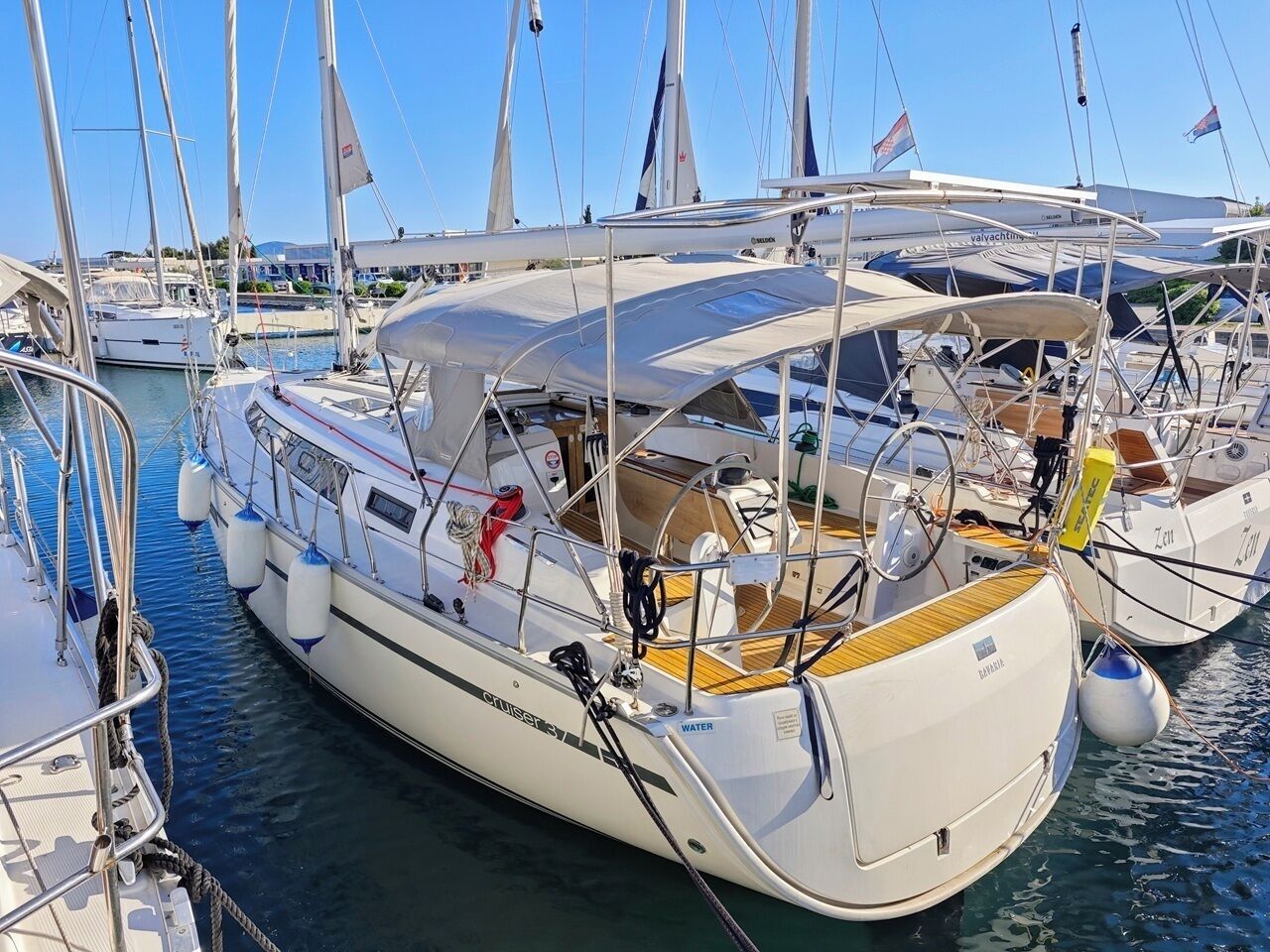 A marina with multiple sailboats docked.