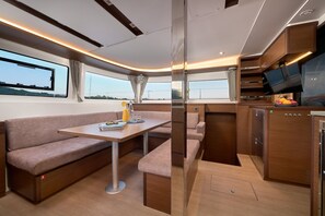 A compact, modern interior with a sofa, table, and built-in TV.