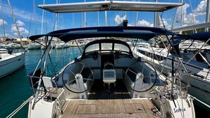 A boat's deck with a steering wheel, a Garmin device, and a Swedish flag. - Sun-Kissed Sailing Adventure in Zadar, Croatia (Bibinje)