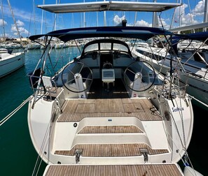 A boat's deck with a steering wheel, a Garmin device, and a Swedish flag. - Sun-Kissed Sailing Adventure in Zadar, Croatia (Bibinje)