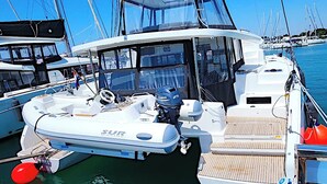 A white motorboat with a cabin, a steering wheel, and a motor labeled 'SUR'. - Sun-Kissed Sailing Adventure in Zadar, Croatia (Bibinje)