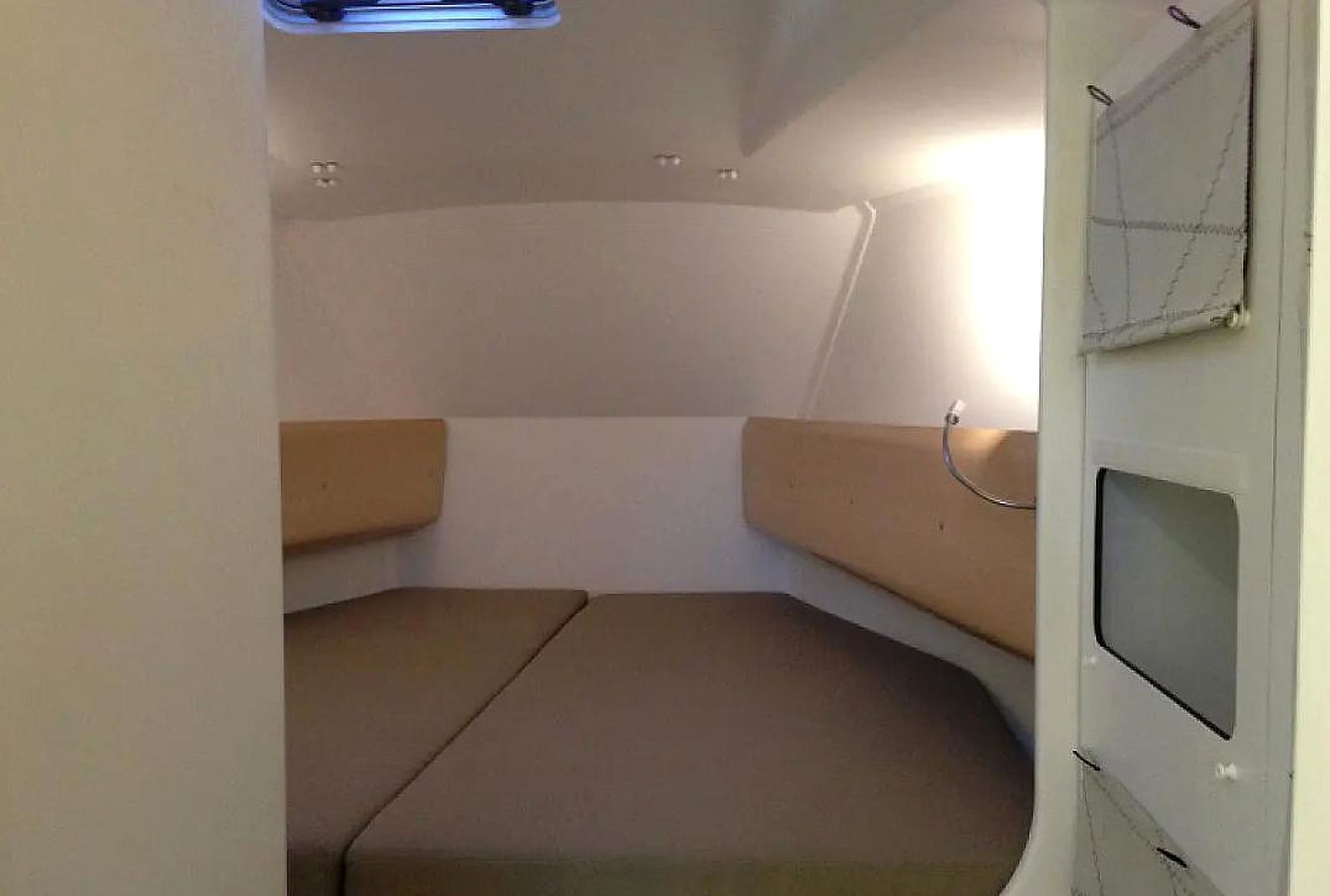 A compact interior with a curved seating area and a small window.