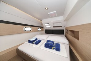 A modern hotel room with a bed, two bedside tables, and a headboard. - Sun-kissed Sailing Adventure in Split-Dalmatia, Croatia (Trogir)