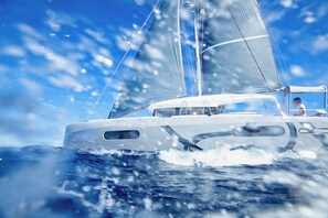 A sailboat with a cabin and deck area, sailing on the water.
