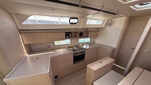 A compact galley with a stove, sink, and storage cabinets. - Sun-Kissed Sailing Adventure in Zadar, Croatia (Bibinje)