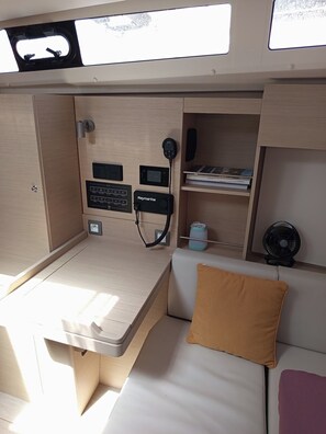 A compact, well-lit cabin with a desk, a bed, and a small shelf with books. - Sun-Kissed Sailing Adventure in the Ionian Islands, Lefkada (Lefkada)