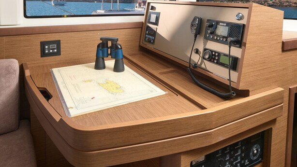 A wooden desk with binoculars, a map, and a control panel with various buttons and screens. - Sun-kissed Sailing Adventure in Split-Dalmatia, Croatia (Trogir)