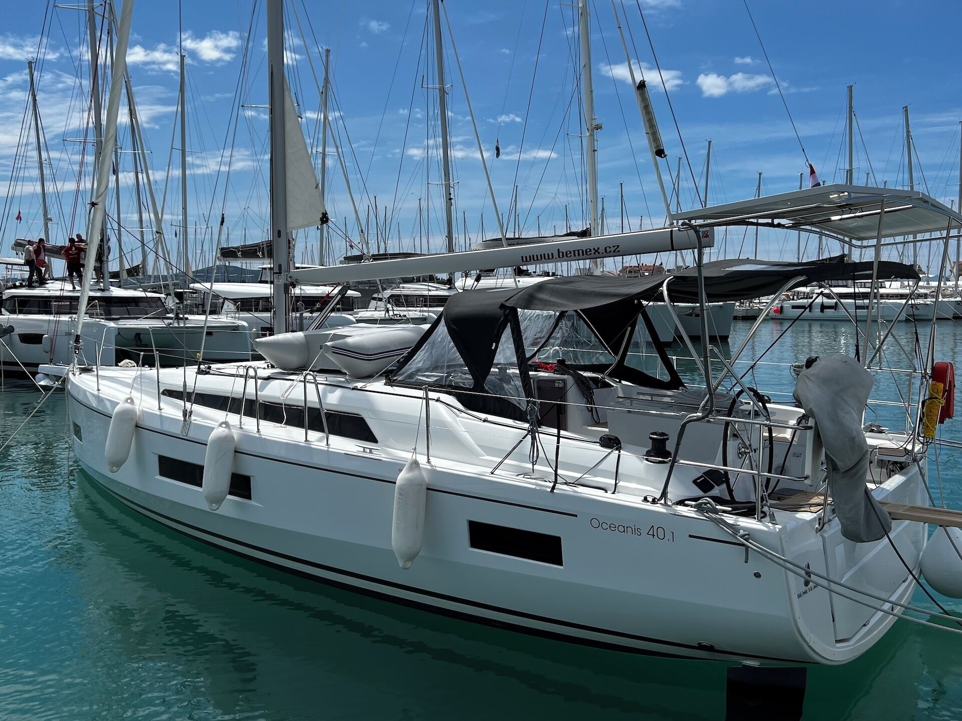 A marina with multiple sailboats docked.