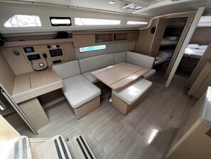A compact interior with a kitchenette, seating area, and a small sleeping berth. - Sun-Kissed Sailing Adventure in Zadar, Croatia (Bibinje)