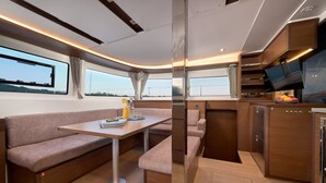 A compact, modern interior with a sofa, table, and built-in TV. - Sun-kissed Sailing Adventure in Split-Dalmatia, Croatia (Trogir)