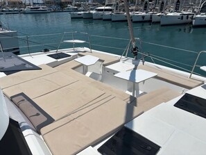 A marina with boats docked, a covered deck area with seating, and a clear view of the water. - Sun-Kissed Sailing Adventure in the Ionian Islands, Lefkada (Lefkada)