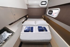 Ein gemütliches Blockhaus mit Bett, kleinem Fenster, Spüle und Spiegel.