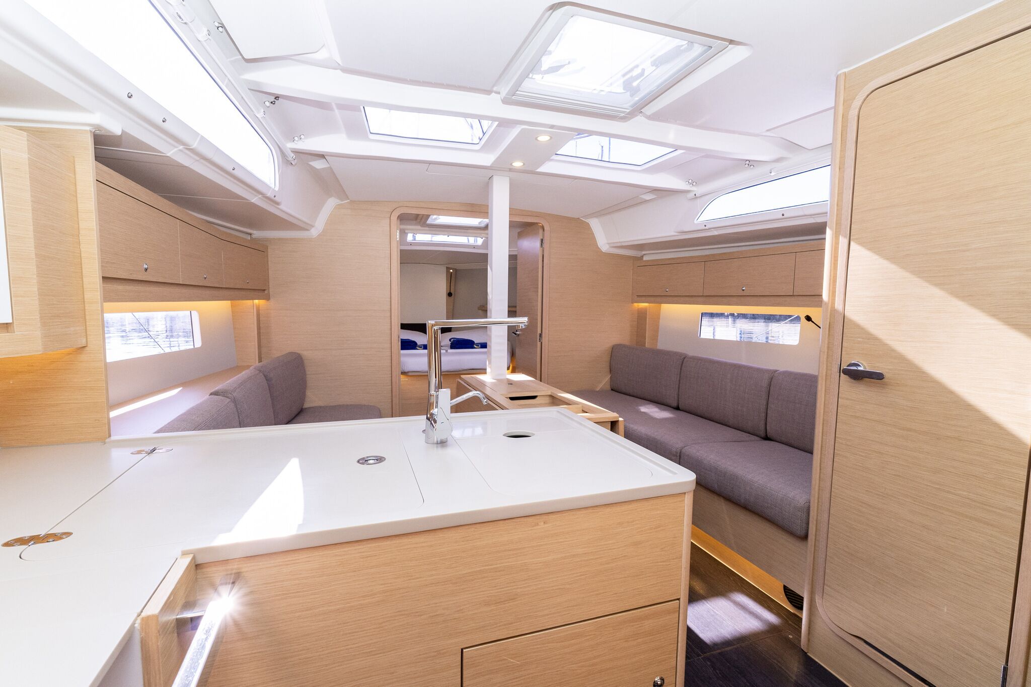 A compact interior with a kitchenette, seating area, and skylights.