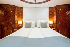 A double bed with white linens, two bedside tables with lamps, and a large mirror above the bed. - Sun-kissed Sailing Adventure in Split-Dalmatia, Croatia (Seget Donji)