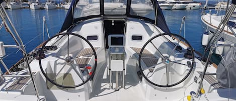 A boat's deck with two steering wheels, a starboard and a port helm, a name 'BERRY' on the starboard side, and a 'DIESEL' label on the port side.