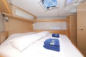 A compact, well-lit room with a bed, a small window, and a wardrobe. - Sibenik Sun and Beach Sailing Extravaganza: A Croatian Coastal Adventure (Vodice)