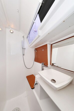 A modern bathroom with a bathtub, a sink, and a shower. - Sun-kissed Sailing Adventure in Split-Dalmatia, Croatia (Trogir)