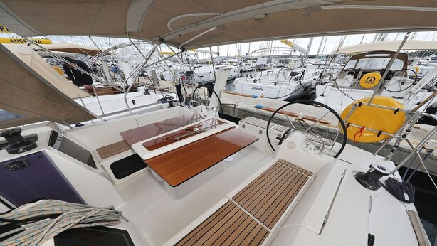 A boat deck with a steering wheel, a lifebuoy, and a cabin area. - Sun-kissed Sailing Adventure in Split-Dalmatia, Croatia (Trogir)