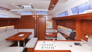 A yacht interior with a dining area, seating, a sink, and a map on the table. - Sun-kissed Sailing Adventure in Split-Dalmatia, Croatia (Trogir)