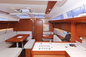 A yacht interior with a dining area, seating, a sink, and a map on the table. - Sun-kissed Sailing Adventure in Split-Dalmatia, Croatia (Trogir)