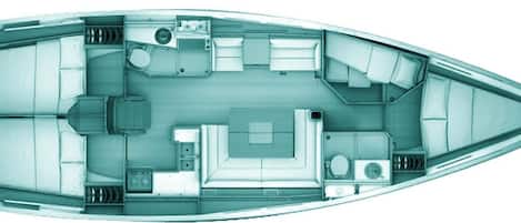 A boat interior with a central seating area, a small kitchen, and a bathroom.