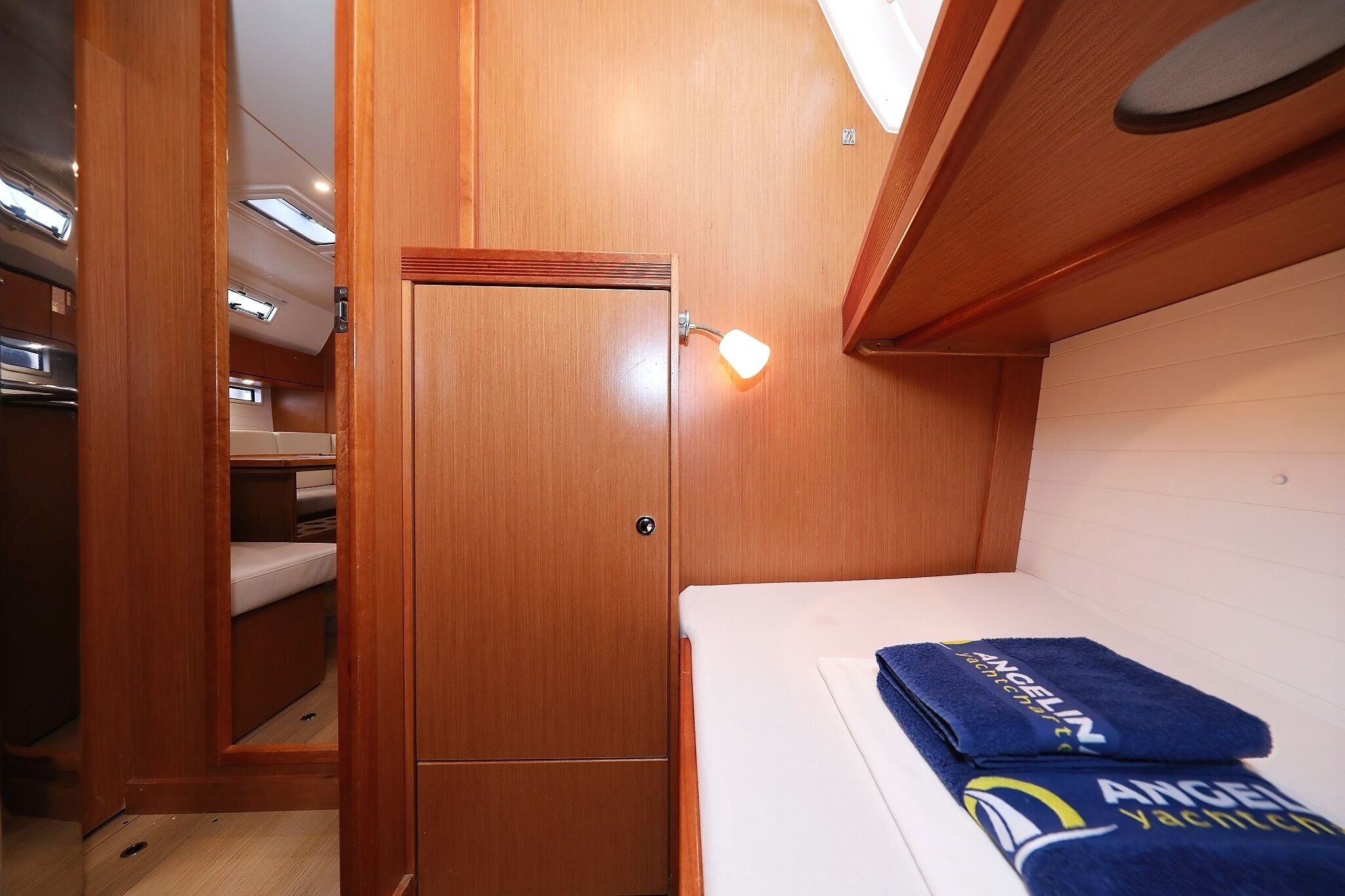 A compact cabin with a bed, a wooden door, and a small window.