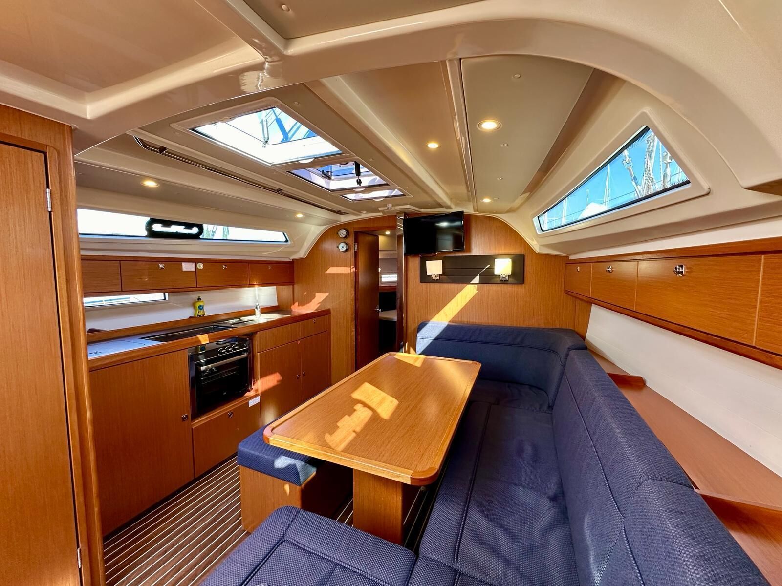 A compact interior with a kitchenette, seating area, and skylights.