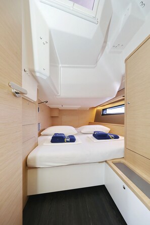 A compact, well-lit cabin with a single bed, storage compartments, and a small window. - Sun-Kissed Sailing Adventure in Istria, Croatia (Pula)