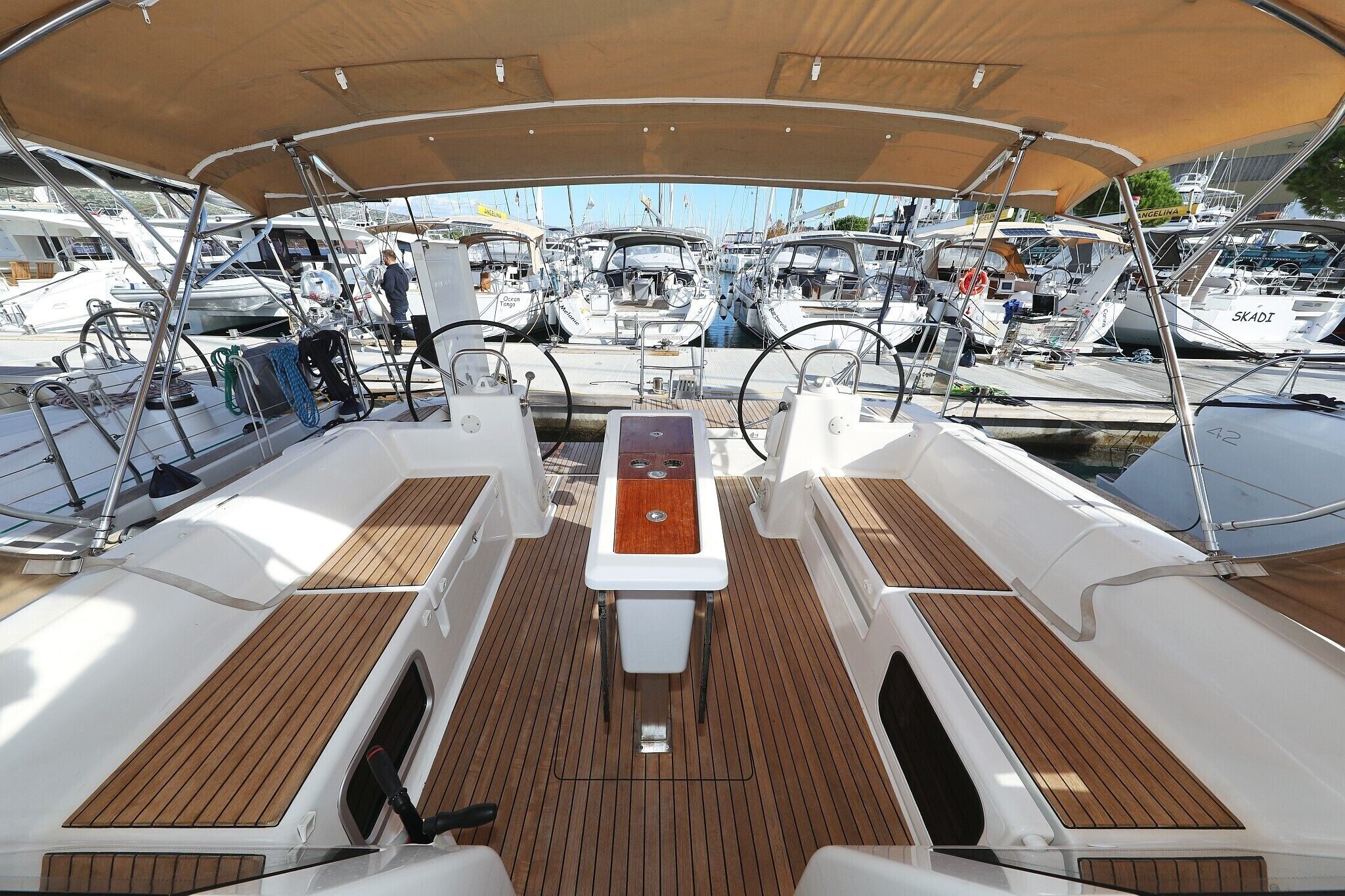 A marina with multiple boats docked, a covered deck area, and a central control station.