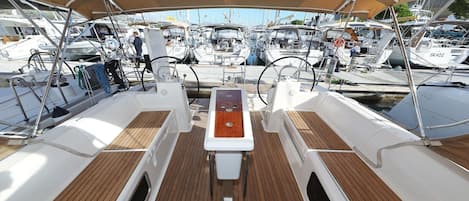 A marina with multiple boats docked, a covered deck area, and a central control station.