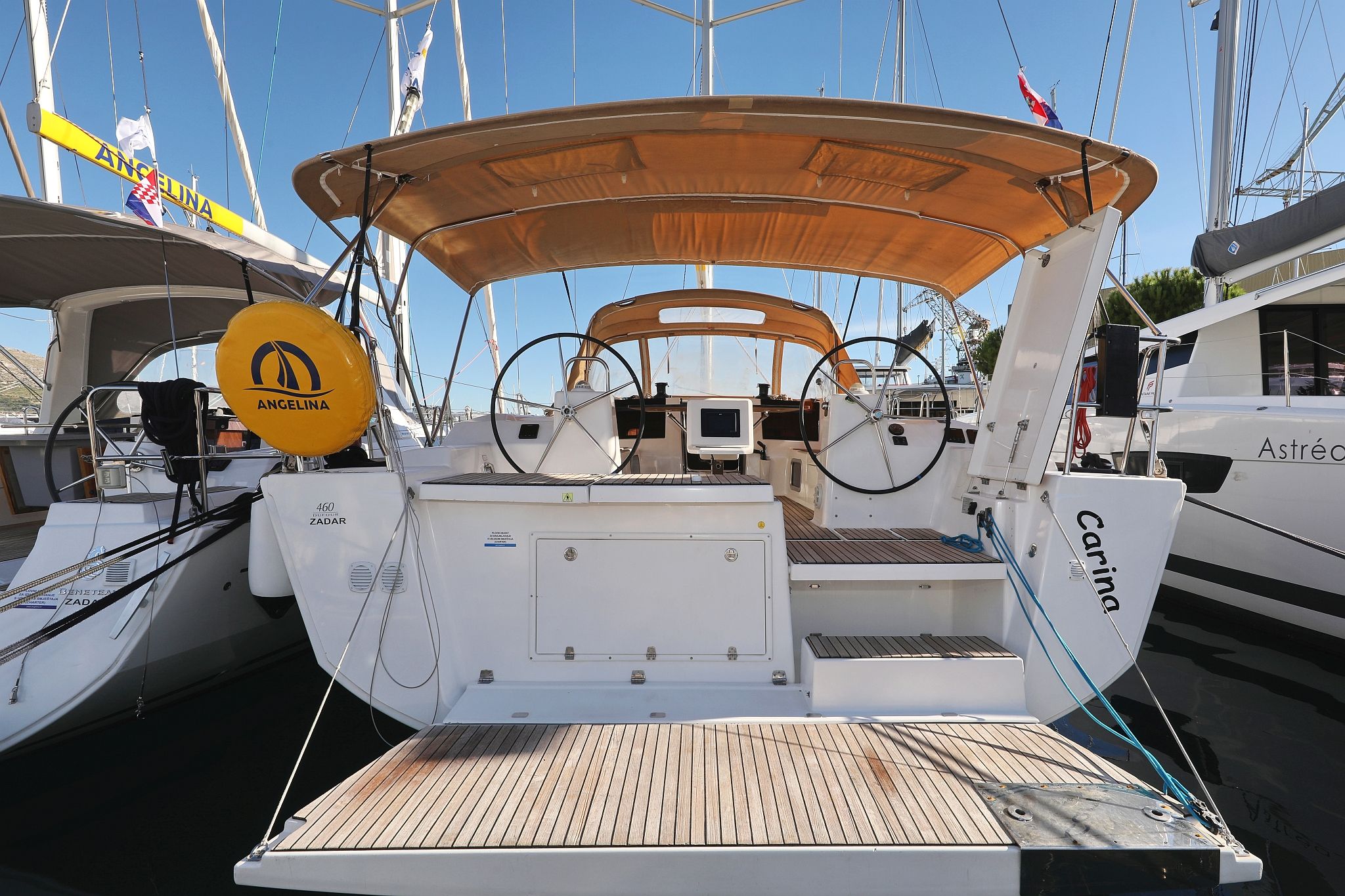 A yacht deck with a canopy, control panels, and a name 'Carina' visible.
