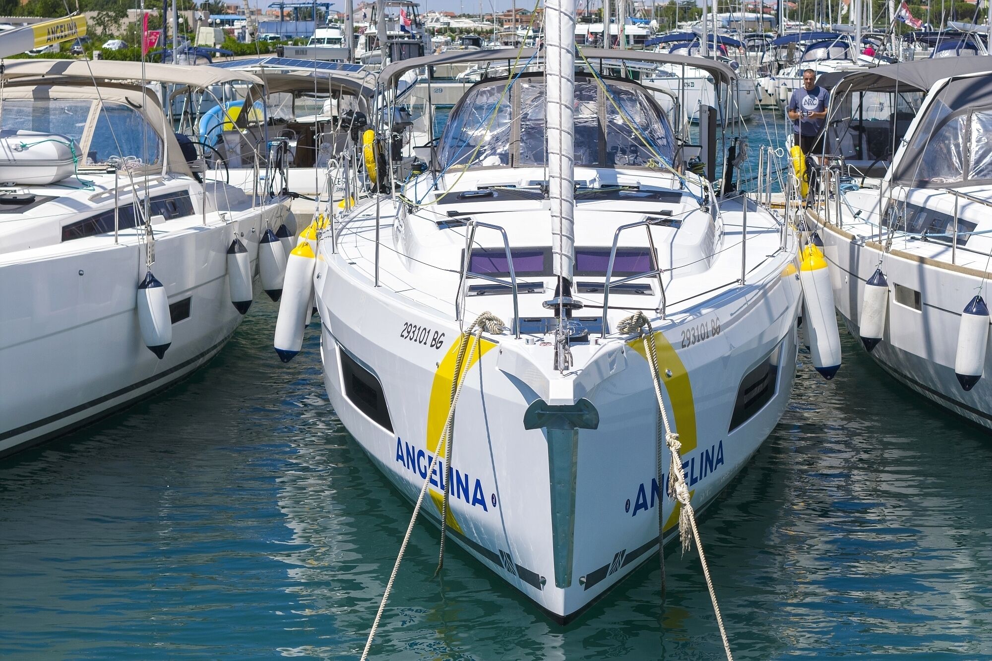 A marina with boats docked, including one with 'ANGELINA' written on it.